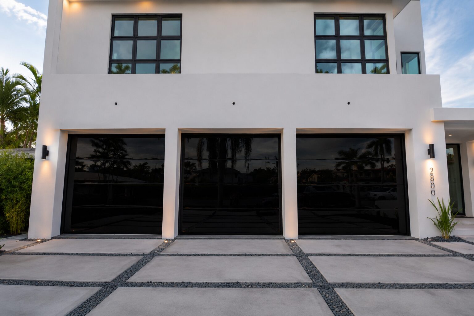 Black full-view glass garage door on a Florida residence