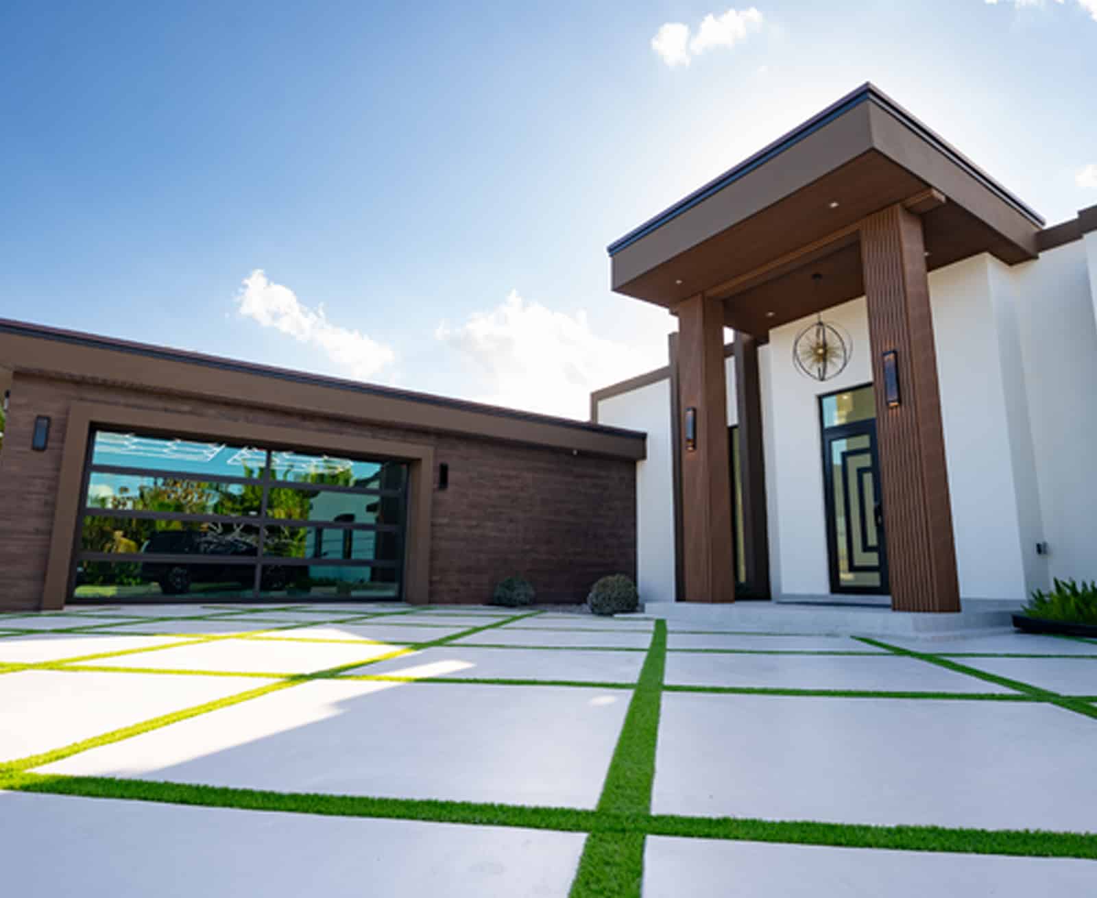 Modern home with a custom full-view glass garage door