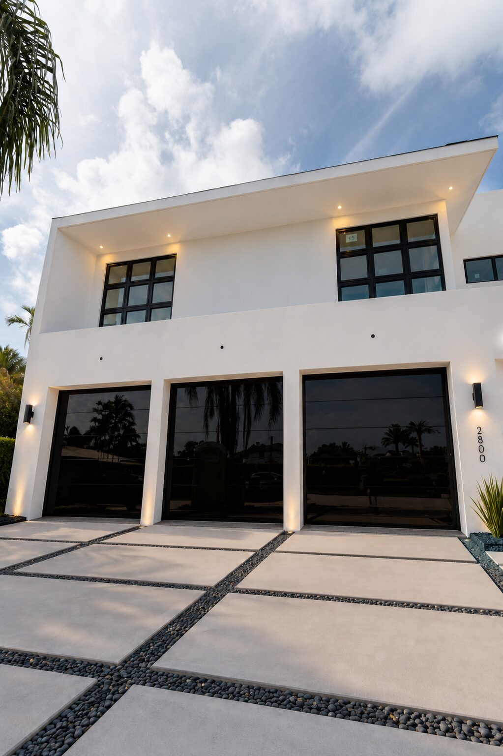 Custom glass garage door viewed from the driveway